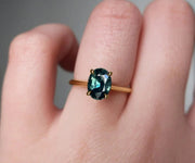Oval-cut lab-grown teal sapphire engagement ring in sterling silver with minimalist design